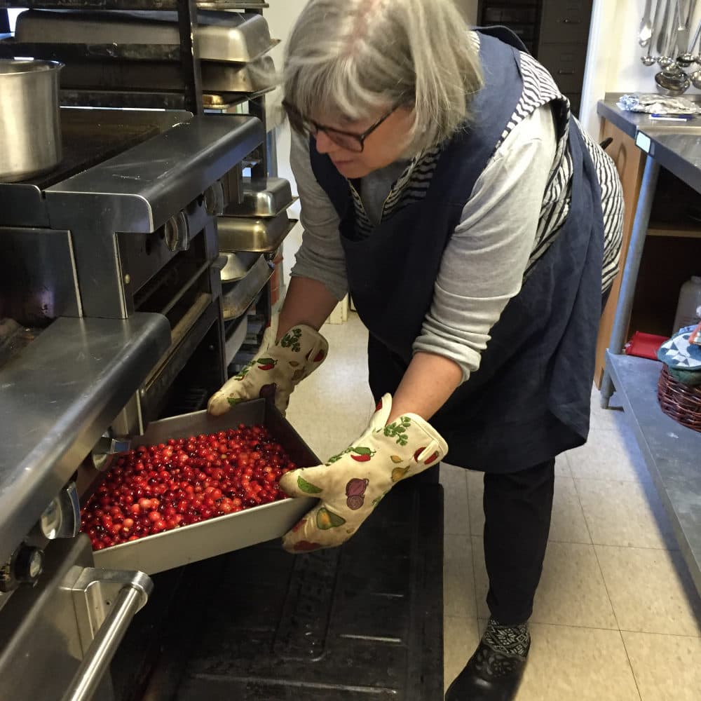 The author making cranberry jam, which requires a lot of Cuisinart chopping of ginger and tangerine peel and pulp. (Courtesy Naomi Schalit)