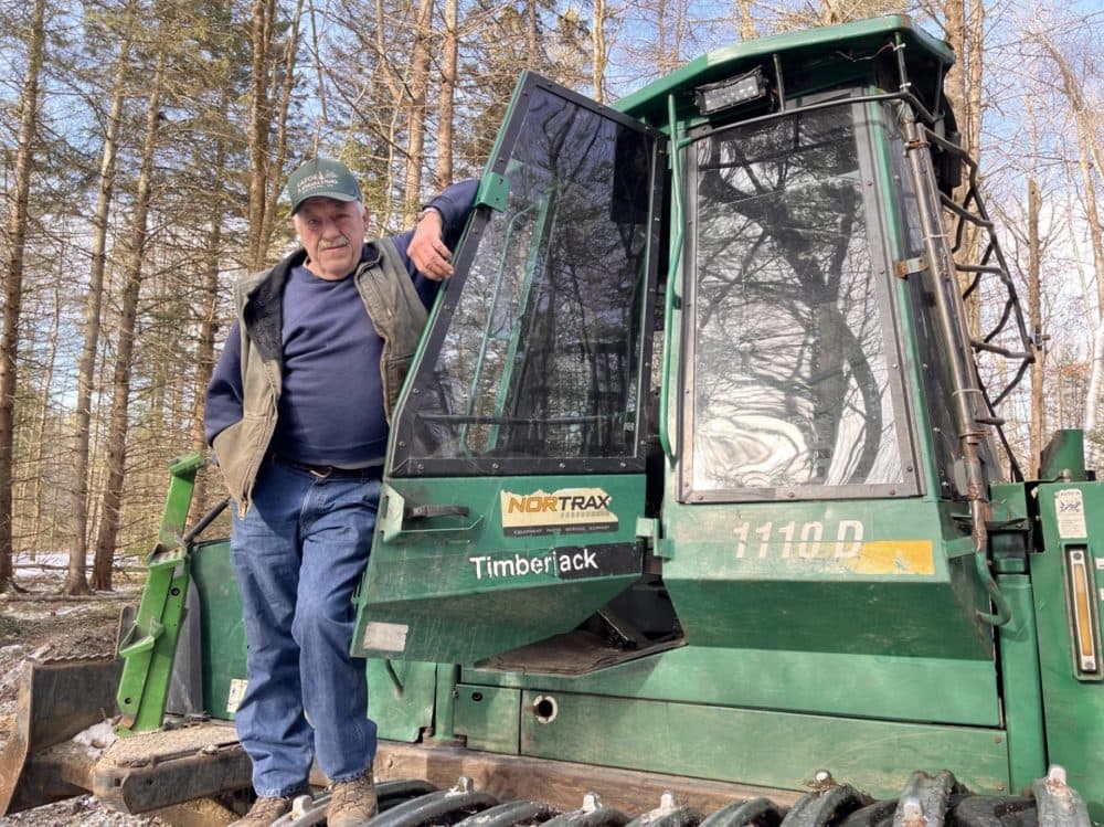 Brian Lafoe, standing outside the cab of his forwarder, says the warm start to winter in Vermont has already taken a toll on his logging business this year. (Henry Epp/Vermont Public)