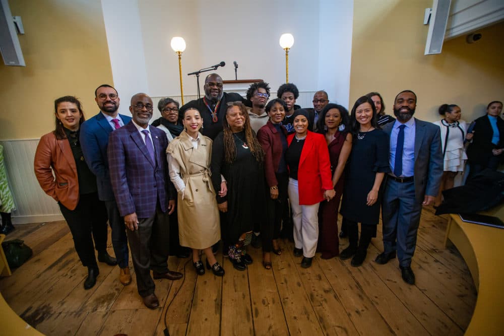Mayor Michelle Wu and other city officials stand with the appointed members of the newly formed Reparations Task Force, created to study the lasting impact of slavery in Boston after the announcement at the Museum of African American History. (Jesse Costa/WBUR)