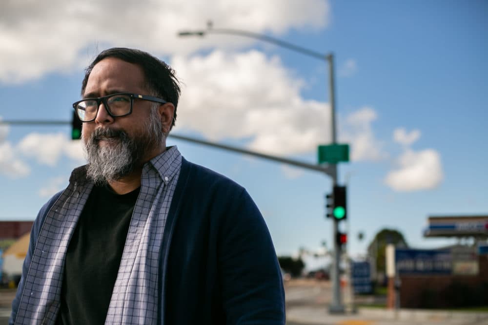 Jason Magabo Perez walks on the corner of Genesee Avenue and Clairmont Mesa Boulevard in San Diego on Thursday, Jan. 19 in San Diego, CA. He mentions this corner of the street in some of his poems. (Courtesy of Brittany Cruz-Fejeran)