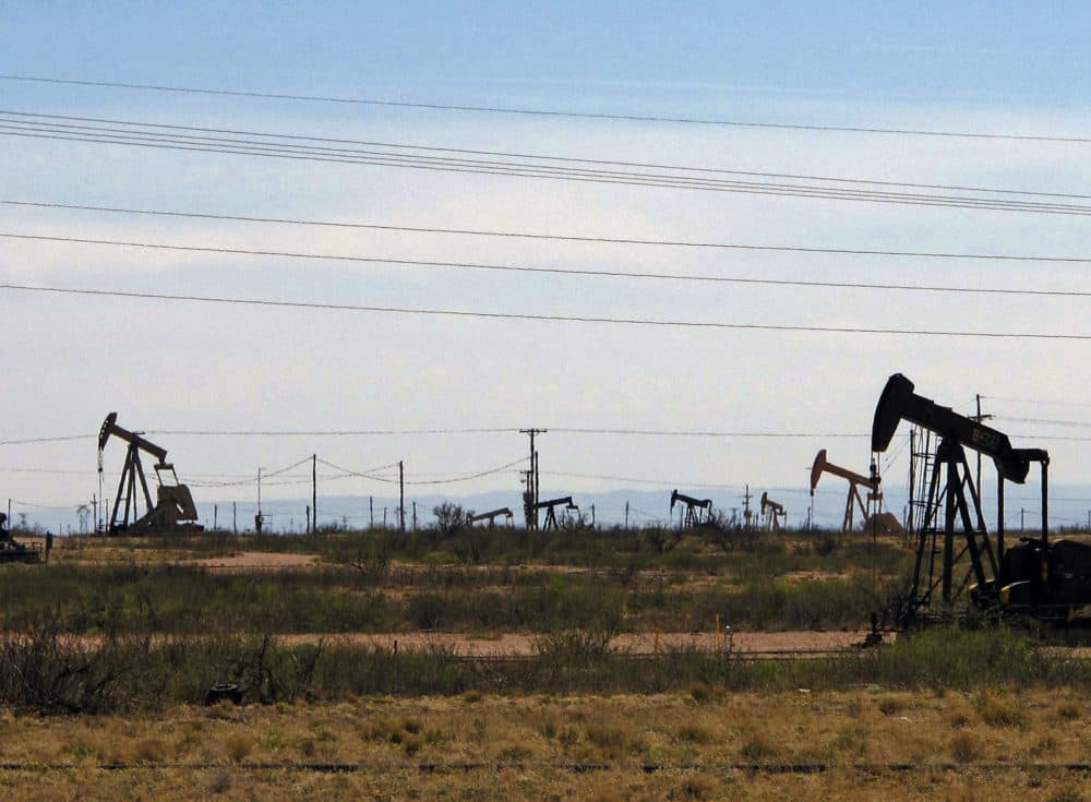 Oil rigs stand in the Loco Hills field along U.S. Highway 82 in Eddy County, near Artesia, N.M. (Jeri Clausing/AP)