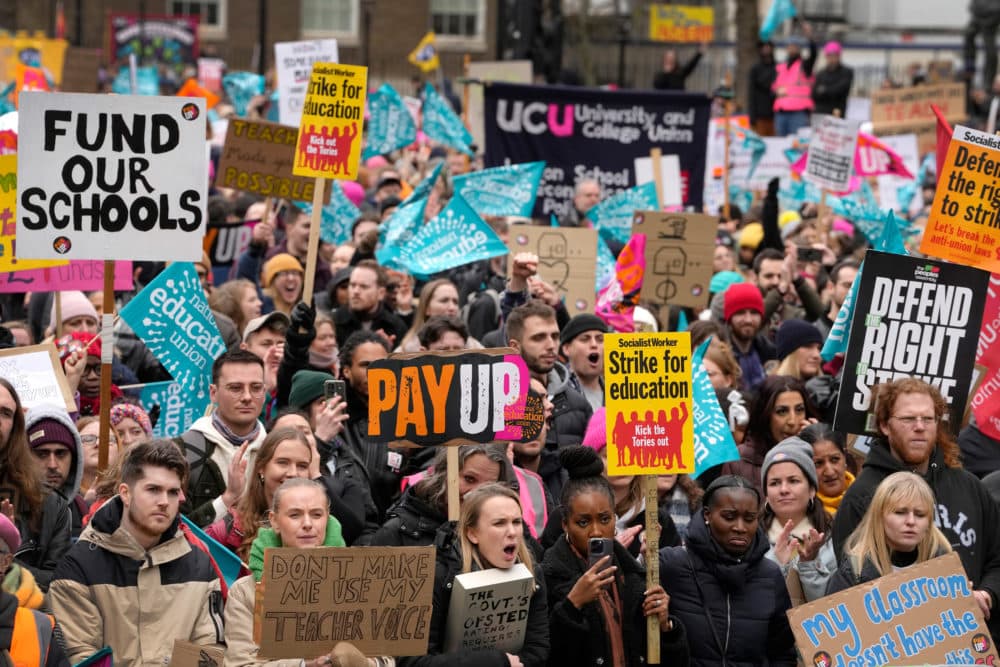 Thousands of schools will close some or all of their classrooms, train services will be paralyzed and delays are expected at airports as teachers, university staff, civil servants, border officials and train and bus drivers walk out of their jobs on the same day. (Kirsty Wigglesworth/AP)