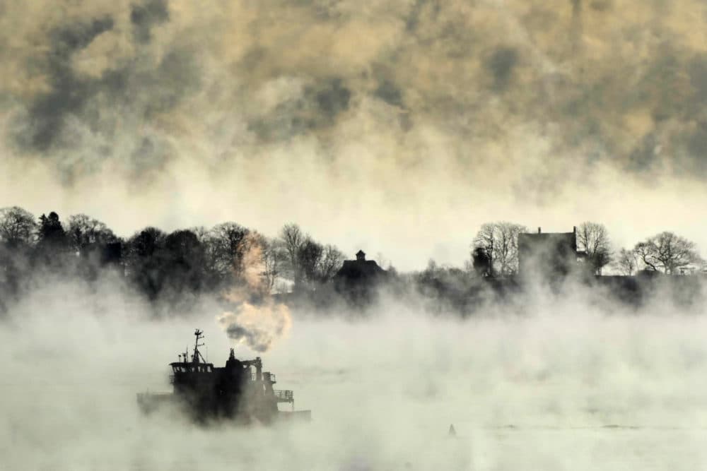 Arctic sea smoke rises from the the Atlantic Ocean as a passenger ferry passes House Island Saturday, Feb. 4, 2023, off the coast of Portland, Maine. (Robert F. Bukaty/AP)