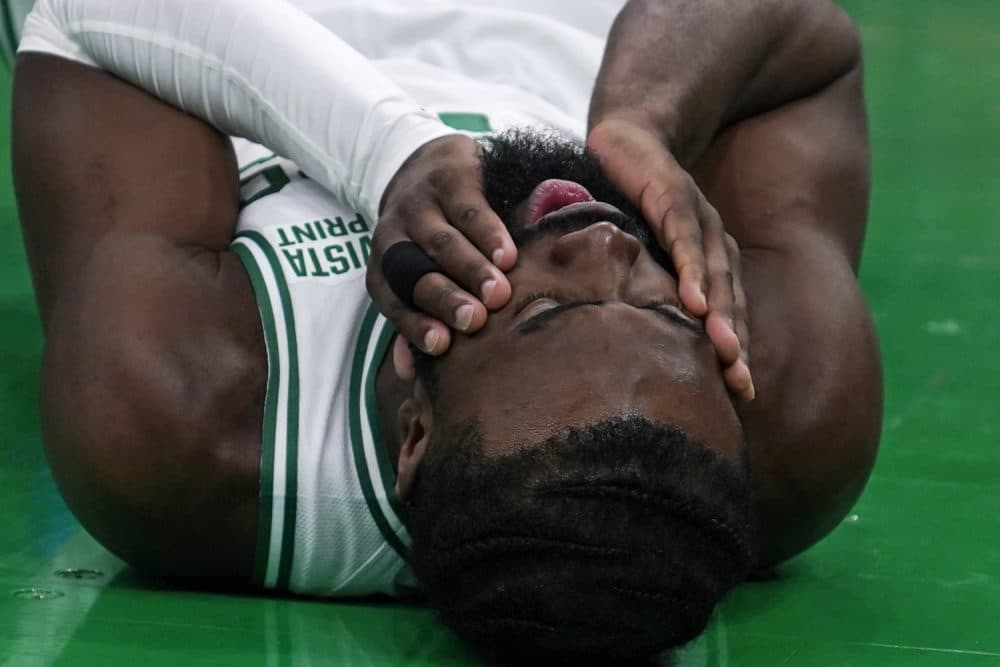 Boston Celtics guard Jaylen Brown (7) grabs his face after colliding with Jayson Tatum during the first half of an NBA basketball game against the Philadelphia 76ers, Wednesday, Feb. 8, 2023, in Boston. (Charles Krupa/AP)