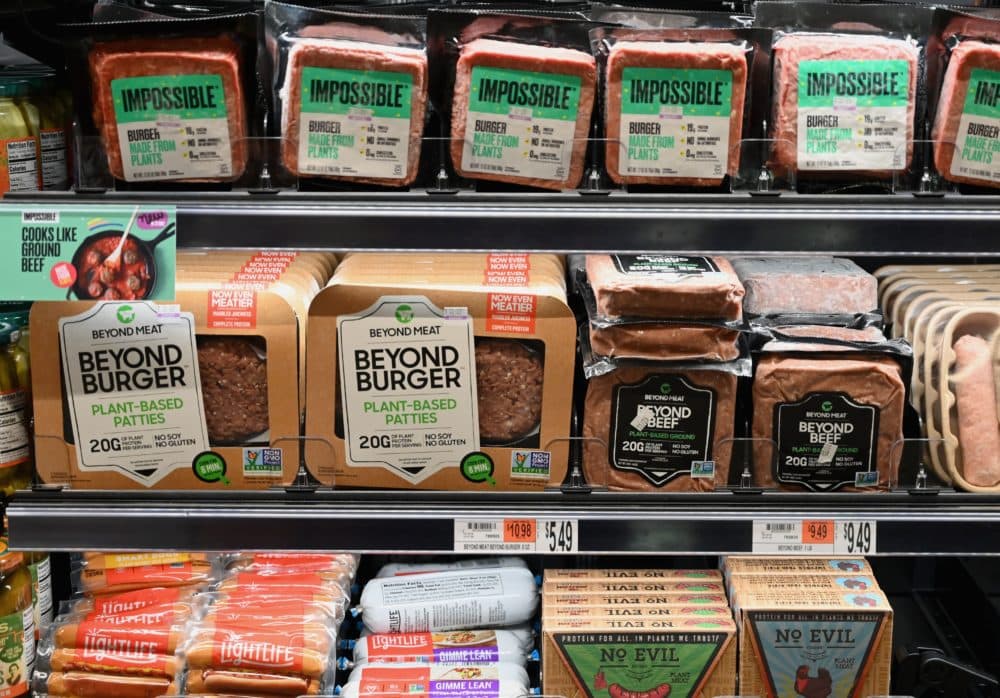 Packages of &quot;Impossible Burger&quot; and &quot;Beyond Meat&quot; sit on a shelf for sale in New York City. (Angela Weiss/AFP via Getty Images)