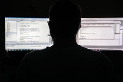 A programmer programmer writes code and works on a computer. (Matic Zorman/Getty Images)