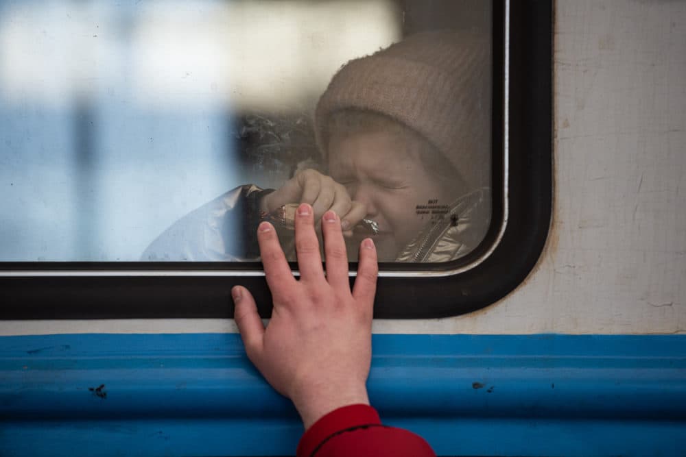 A young girl cries as a man says goodbye to his daughter at the railway station on March 22, 2022 in Lviv, Ukraine. (Alexey Furman/Getty Images)
