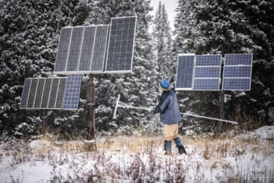 Billy Barr clears snow off the several solar panels that power his home in  Gothic, Colorado. Barr has kept detailed snow reports, weather reports, and animal sightings for decades, and his information has become a resource for climate scientists studying the region. (Chet Strange for The Washington Post via Getty Images)
