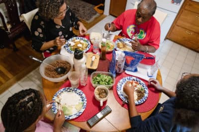 Nicole Boynes, 46, has dinner with her daughters, Sierra, 13, and Gabrielle, 10, and her mother-in-law, Germaine Boynes, 77, at their house in Silver Spring, MD on March 7, 2022. (Shuran Huang for The Washington Post via Getty Images)