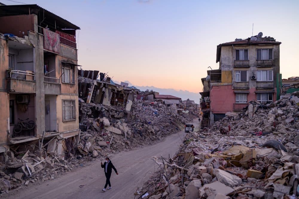 A man walks past collapsed buildings in Antakya, southern Turkey on Feb. 20, 2023. (Yasin Akgul/AFP via Getty Images)