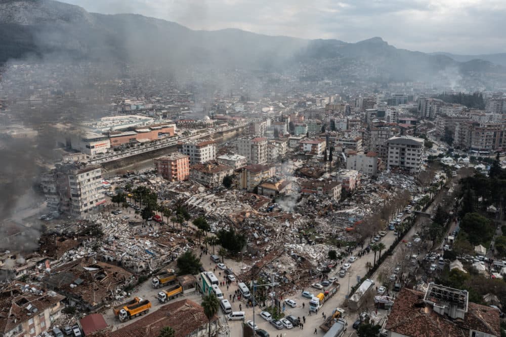 Smoke billows from the scene of a collapsed buildings on Feb. 07, 2023 in Hatay, Turkey. A 7.8-magnitude earthquake hit near Gaziantep, Turkey, in the early hours of Monday, followed by another 7.5-magnitude tremor just after midday. The quakes caused widespread destruction in southern Turkey and northern Syria and were felt in nearby countries. (Burak Kara/Getty Images)