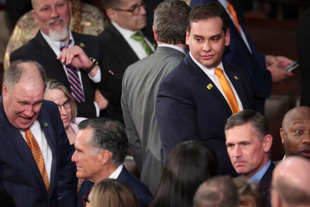 U.S. Rep. George Santos (R-NY) (top right) watches as Sen. Mitt Romney (R-UT) (bottom left) enters the House chamber for President Joe Biden's State of the Union address during a joint meeting of Congress in the House Chamber of the U.S. Capitol on February 07, 2023 in Washington, DC.  (Win McNamee/Getty Images)