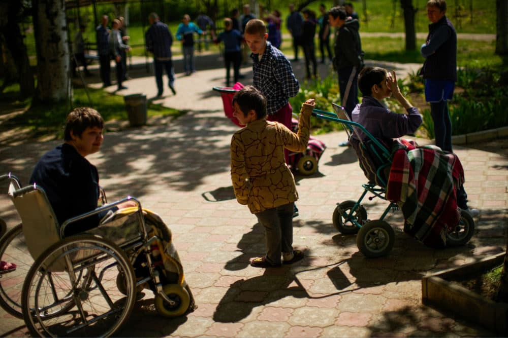 Residents spend time outdoors in a facility for people with mental and physical disabilities in the village of Tavriiske, Ukraine. The staff is faced with the dilemma of evacuating the facility. (Francisco Seco/AP)