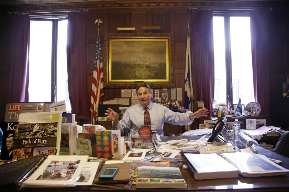 In this June 5, 2014 photo, Springfield Mayor Domenic Sarno sits behind his city hall desk reiterating the position he has taken with the United States State Department against accepting any more resettled refugees in Springfield, Mass. Sarno is the latest mayor to decry refugee resettlement, joining counterparts in New Hampshire and in Maine in largely rare tensions with the State Department. (AP Photo/Stephan Savoia)
