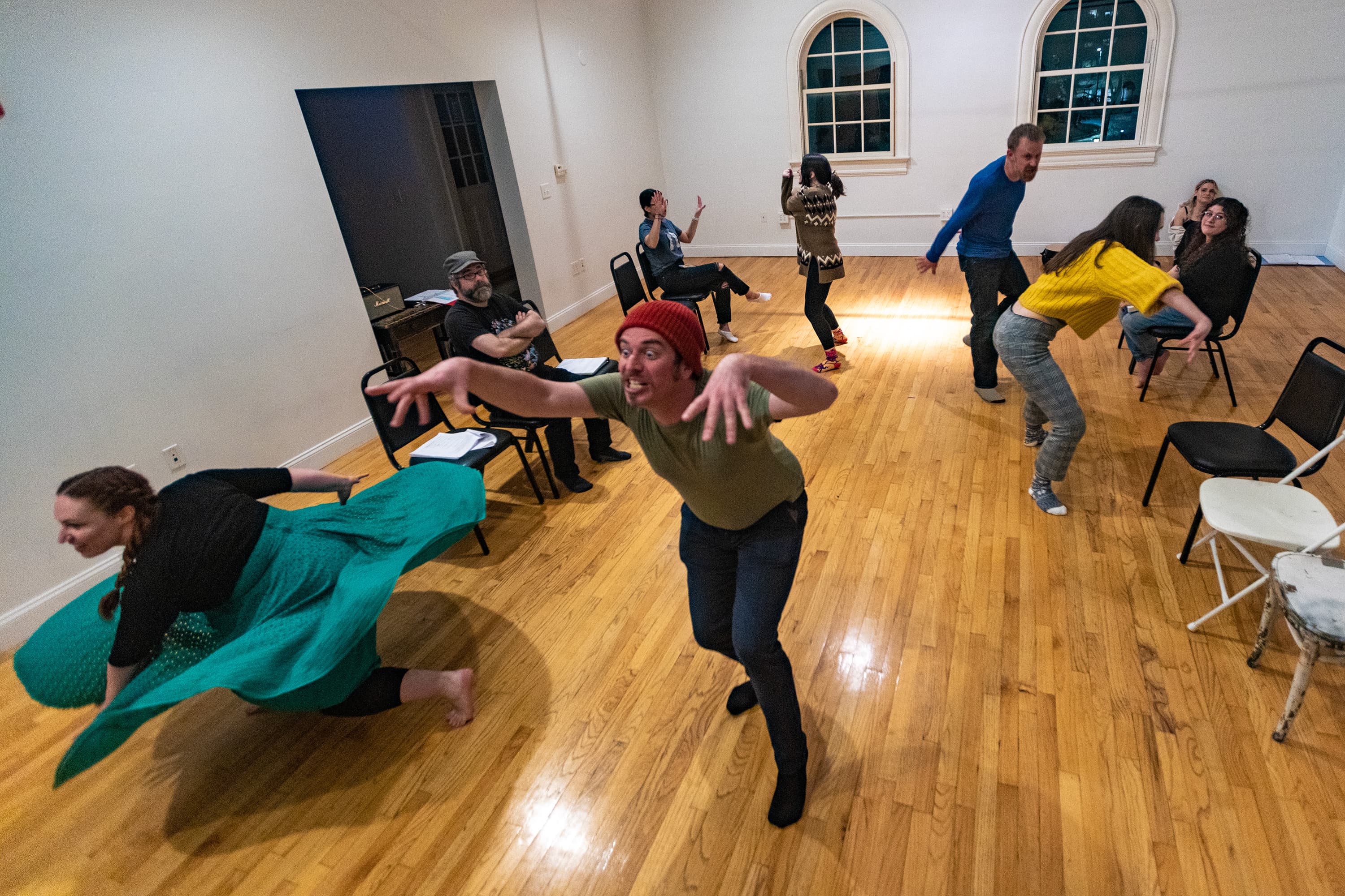 The cast of “T: An MBTA Musical” rehearse at the Somerville Armory ahead of their new season of shows beginning in March at the Rockwell in Davis Square. (Jesse Costa/WBUR)
