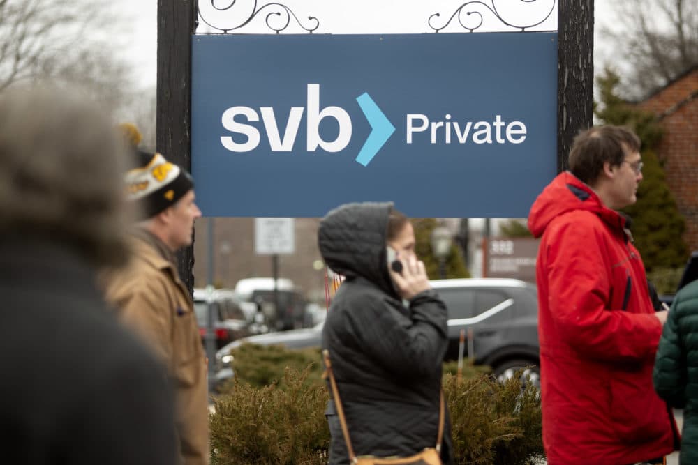 People wait in line Monday outside the Silicon Valley Bank in Wellesley. (Robin Lubbock/WBUR)