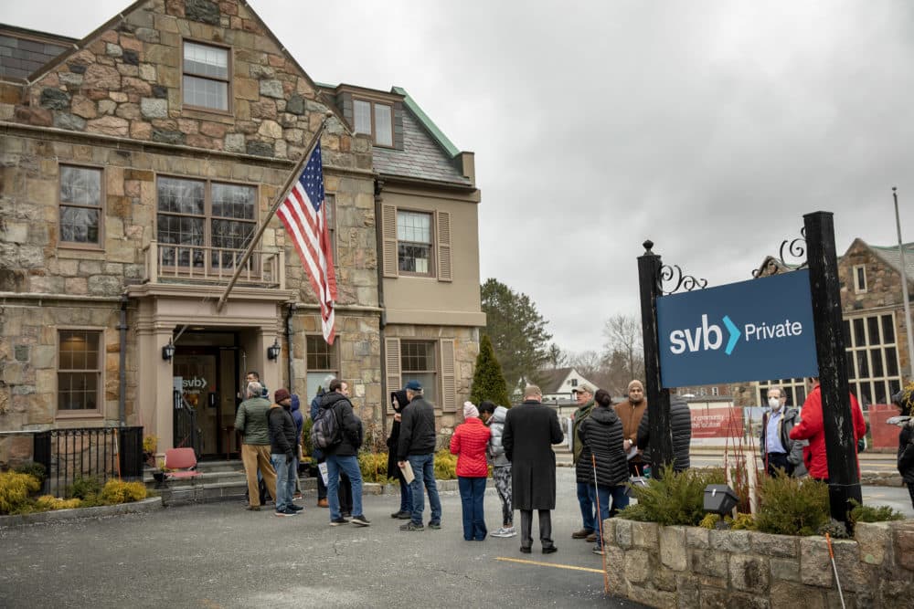 People wait in line outside the Silicon Valley Bank in Wellesley. (Robin Lubbock/WBUR)