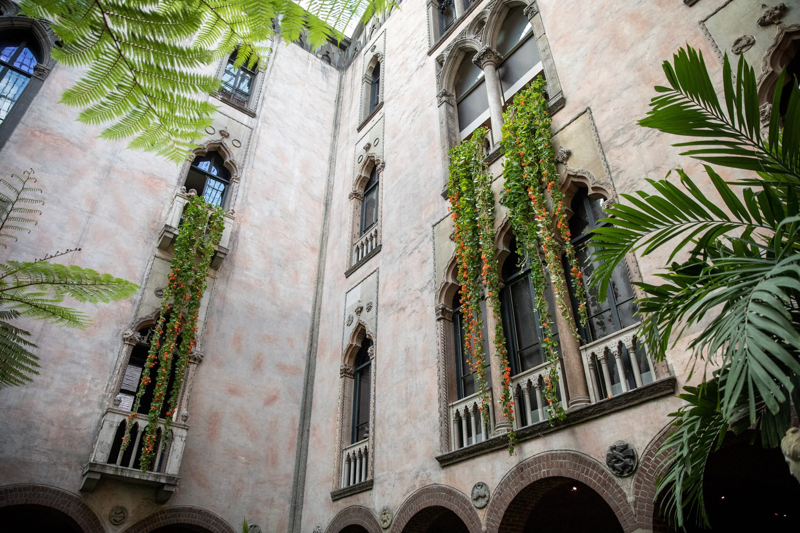 Nasturtium plants hang down from the windows in the courtyard of the Isabella Stewart Gardner Museum, during the annual Hanging Nasturtiums installation. (Robin Lubbock/WBUR)