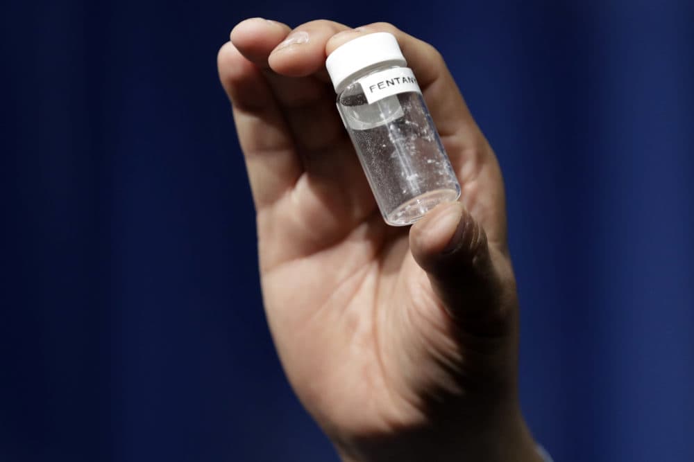 A reporter holds up an example of the amount of fentanyl that can be deadly. (Jacquelyn Martin/AP)