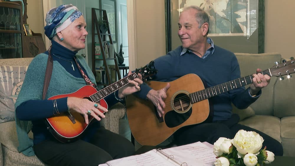 Lynda Shannon Bluestein, left, jams with her husband Paul in the living room of their home, Feb. 28, 2023, in Bridgeport, Conn. (Rodrique Ngowi/AP Photo)