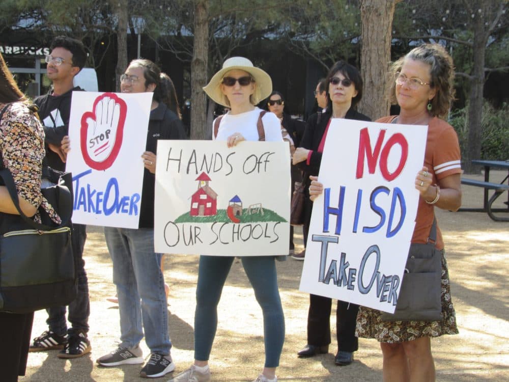 People hold up signs at a news conference, Friday, March 3, 2023, in Houston while protesting the proposed takeover of the city's school district by the Texas Education Agency. Texas officials on Wednesday, March 15, announced a state takeover of Houston's nearly 200,000-student public school district, the eighth-largest in the country, acting on years of threats and angering Democrats who assailed the move as political. (Juan A. Lozano/AP)