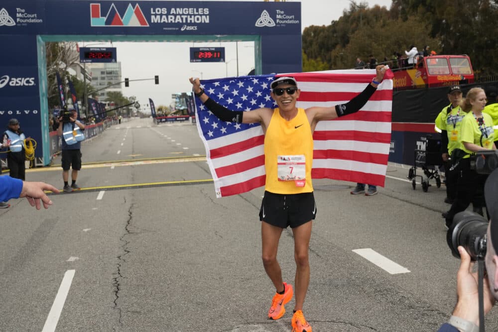 Hosava Kretzmann, of Prescott, Ariz., celebrates after crossing the finish line as the top American men's finisher in sixth at the Los Angeles Marathon in Los Angeles, on Sunday, March 19, 2023. (Damian Dovarganes/AP)
