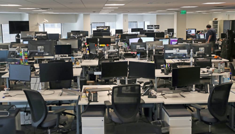 Nearly empty desks at the Fuze office in Boston on March 10, 2020. (David L. Ryan/The Boston Globe via Getty Images)