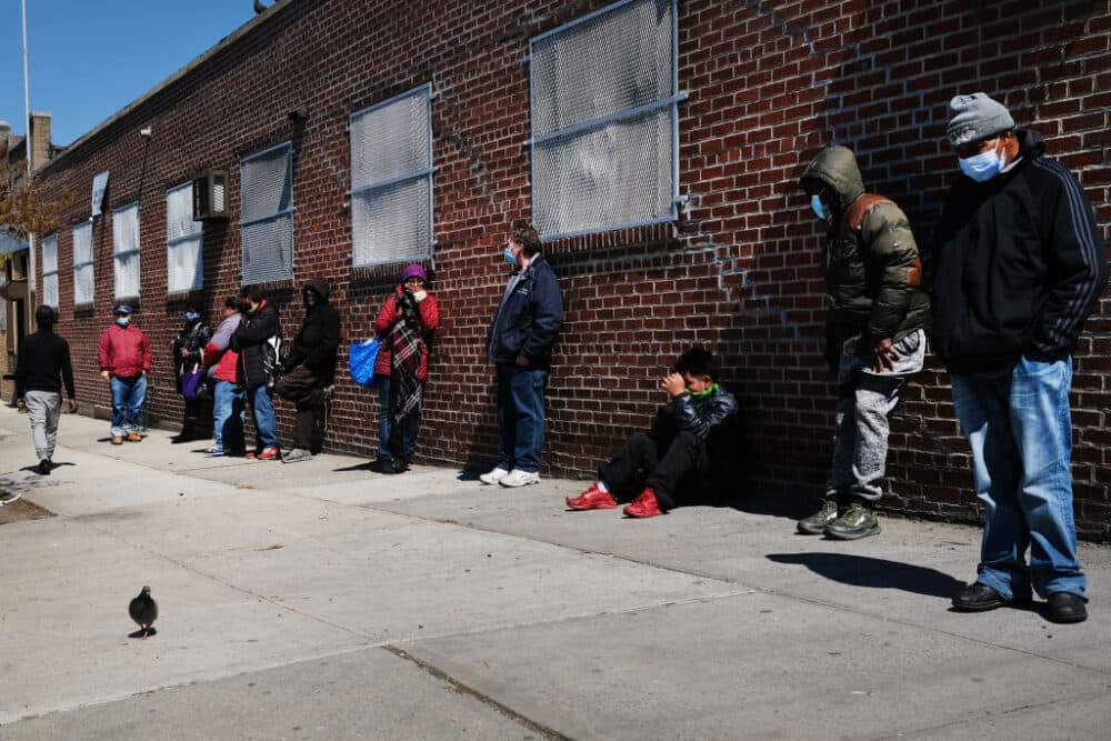 NEW YORK, NEW YORK - APRIL 28: People wait in line to receive food at a food bank on April 28, 2020 in the Brooklyn borough of New York City. Food banks around the nation have witnessed a surge in clients as millions of Americans have either lost jobs or seen a decline in income due to the continued closure of businesses and economic life because of the coronavirus pandemic. (Photo by Spencer Platt/Getty Images)