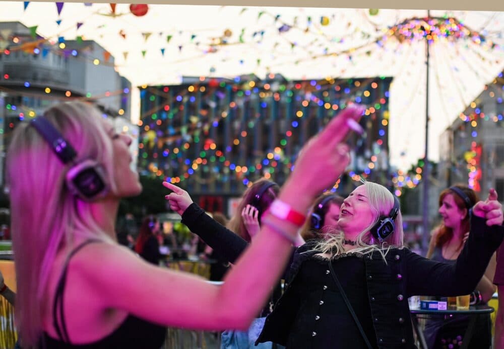 Participants dance while listening to music over headphones. (Ina Fassbender/AFP via Getty Images)