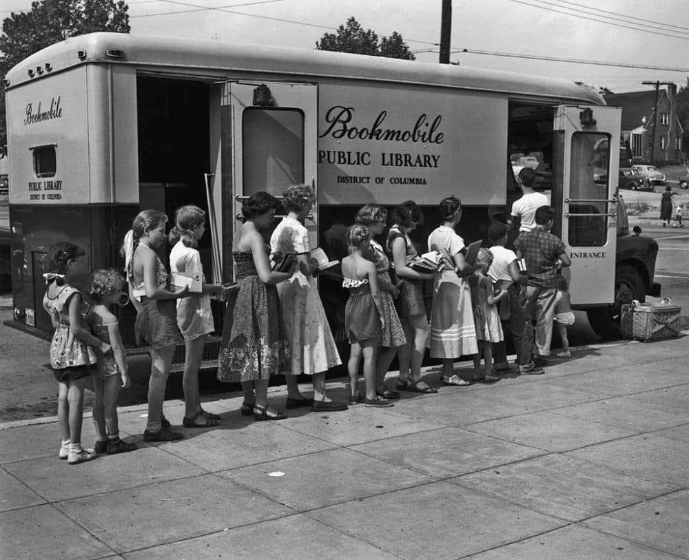 Readers queuing outside a bookmobile, or mobile library, in Washington, D.C., circa 1955. (Photo by FPG/Hulton Archive/Getty Images)