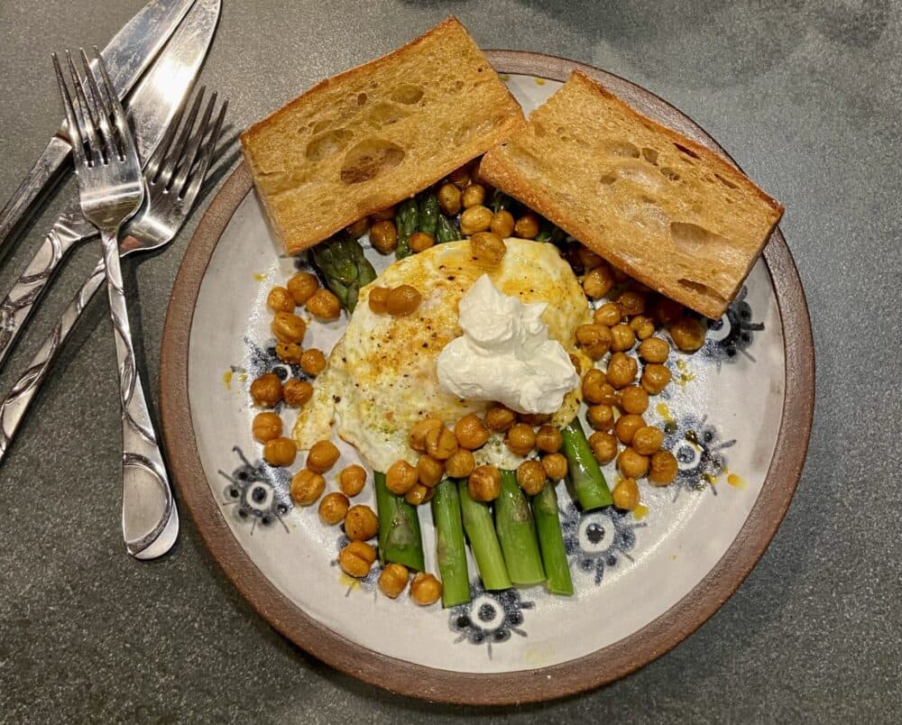 Fried eggs, asparagus, and oven-roasted chickpeas with olive oil toasted baguette. (Kathy Gunst/Here & Now)