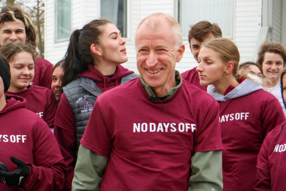 Sandy Hulme (center) wearing his &quot;no days off&quot; t-shirt as part of a celebration at Alma College for his 50-year running streak. Hulme says he's run at least one mile every day since March 5, 1973. (Rick Brewer/WCMU)