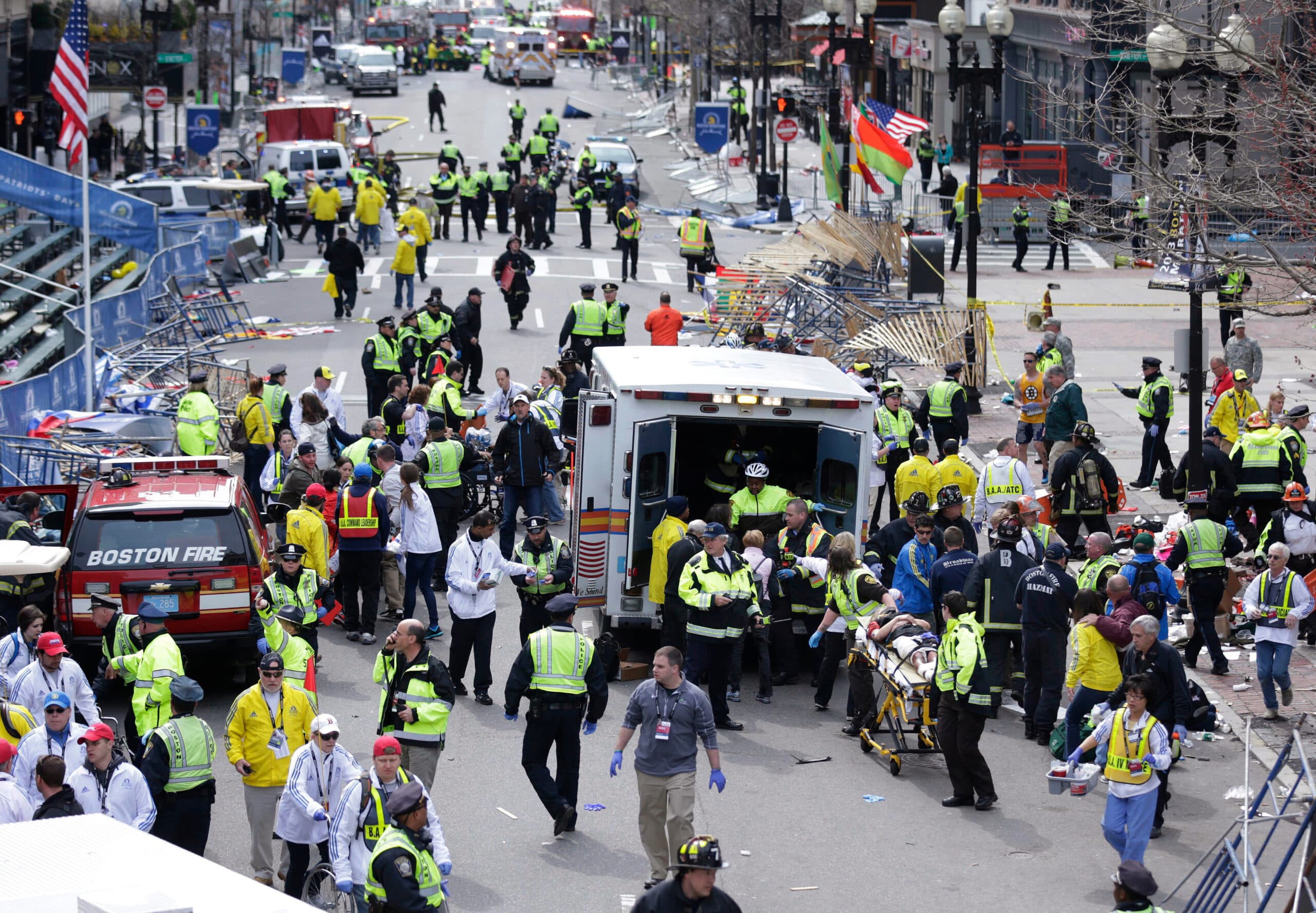 In this 2013 file photo, medical workers rush around an ambulance to treat people wounded after the Boston Marathon bombings. (Charles Krupa/AP)