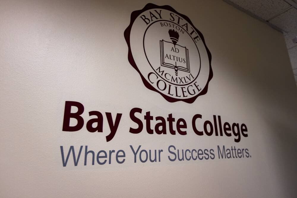 The logo of Bay State College on a wall inside the Back Bay campus.