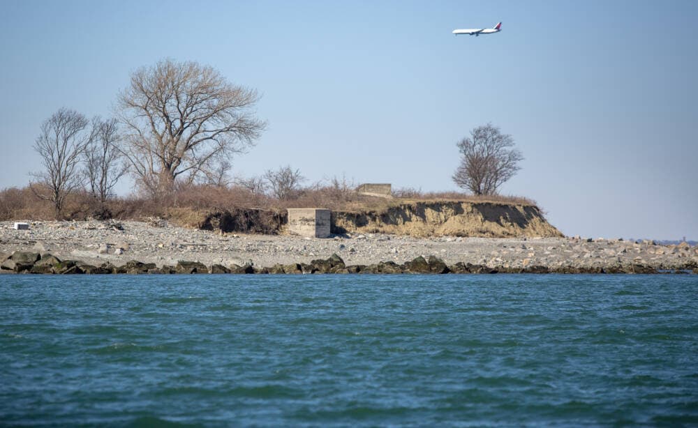 A once hidden concrete structure now stands half exposed as Lovells Island recedes due to ocean erosion. (Robin Lubbock/WBUR)