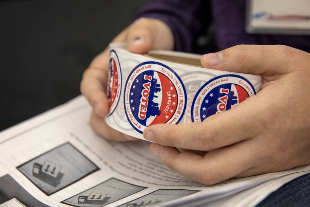 A Cambridge poll worker prepares to hand out &quot;I voted&quot; stickers. (Robin Lubbock/WBUR)