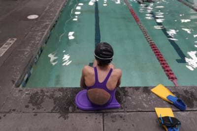 A 12-year-old transgender swimmer is seen waiting by a pool on Feb. 22, 2021 in Utah. (Rick Bowmer/AP)