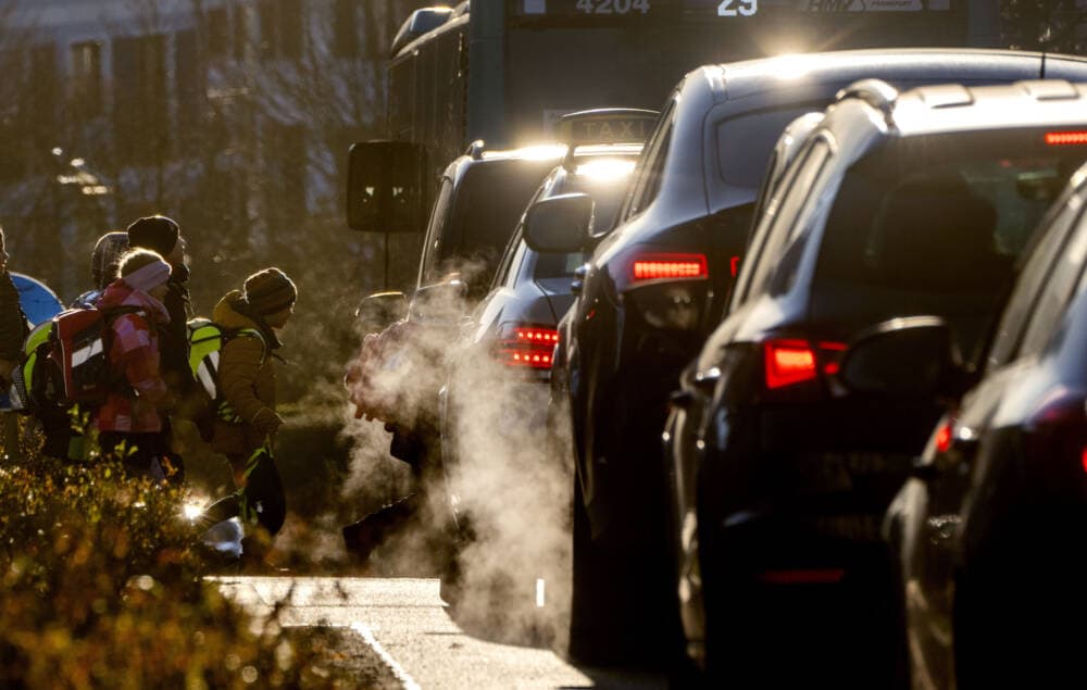 Cars give off exhaust fumes. (Michael Probst/AP)