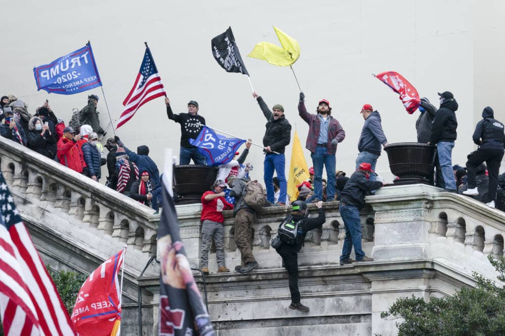 Rioters wave flags on the West Front of the U.S. Capitol in Washington on Jan. 6, 2021. (Jose Luis Magana/AP)