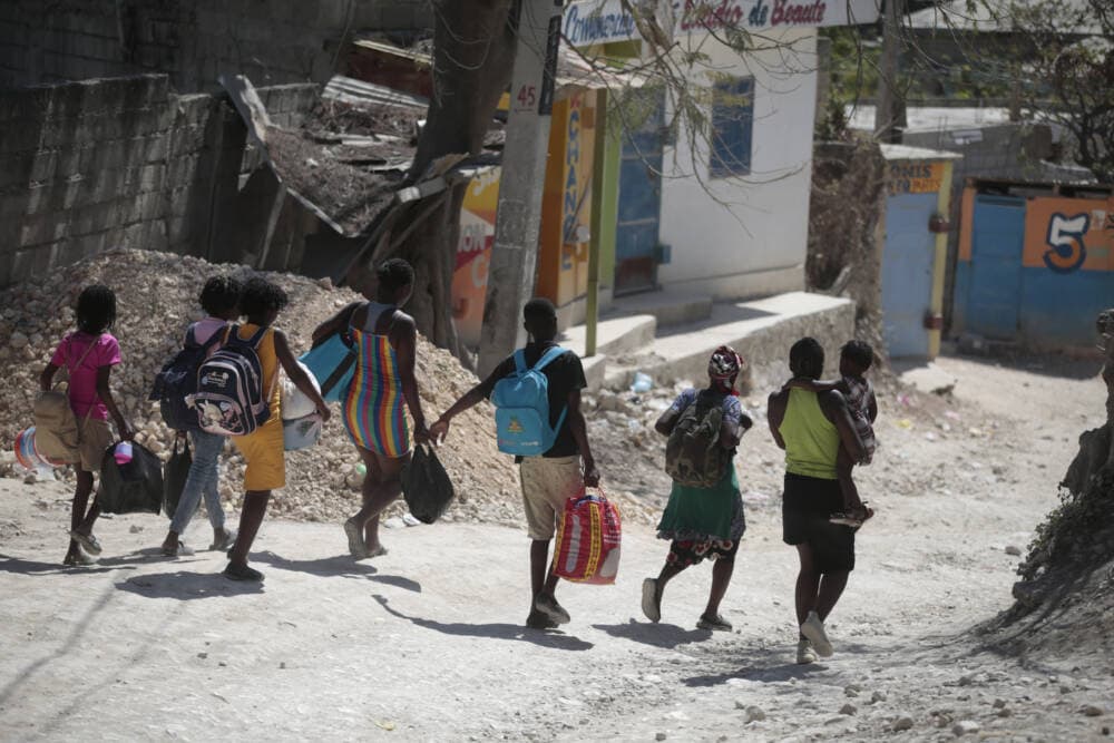 People flee their homes to avoid clashes between armed gangs in the Diegue district of Petion-Ville, Haiti. (Odelyn Joseph/AP)