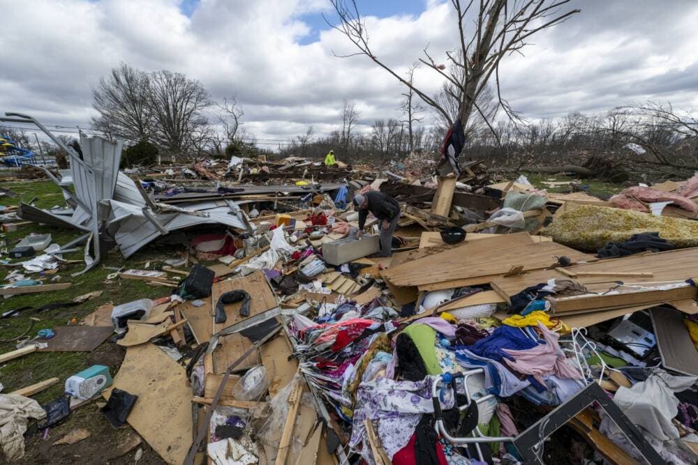 People walk through damage from a late-night tornado in Sullivan, Ind. (Doug McSchooler/AP)