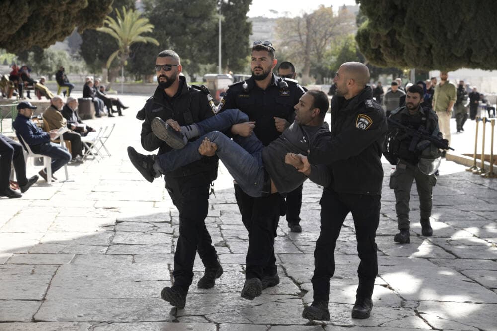 Israeli police detain a Palestinian in the Al-Aqsa Mosque compound following a raid of the site in the Old City of Jerusalem during the Muslim holy month of Ramadan, Wednesday, April 5, 2023. Palestinian media reported police attacked Palestinian worshippers, raising fears of wider tension as Islamic and Jewish holidays overlap.(/Mahmoud Illean/AP)
