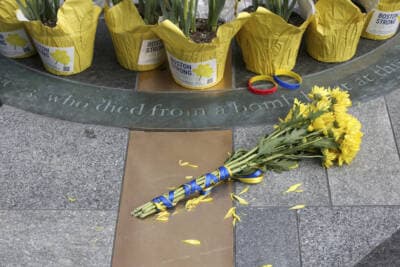 Flowers are placed at a memorial for victims of the 2013 Boston Marathon bombing. (Reba Saldanha/AP)