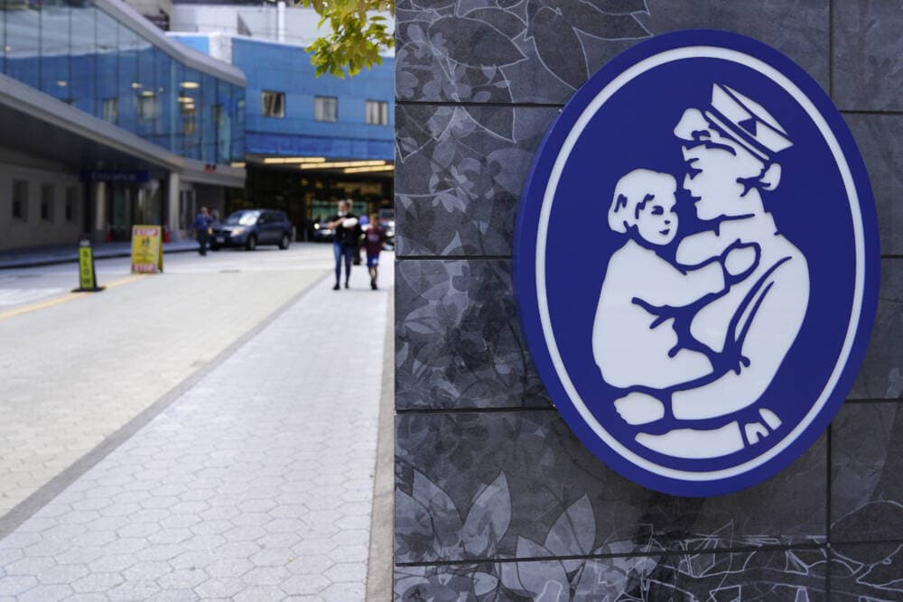 The logo of a nurse holding a child hangs on a wall outside the Boston Children's Hospital, Aug. 18, 2022, in Boston. (Charles Krupa/AP)