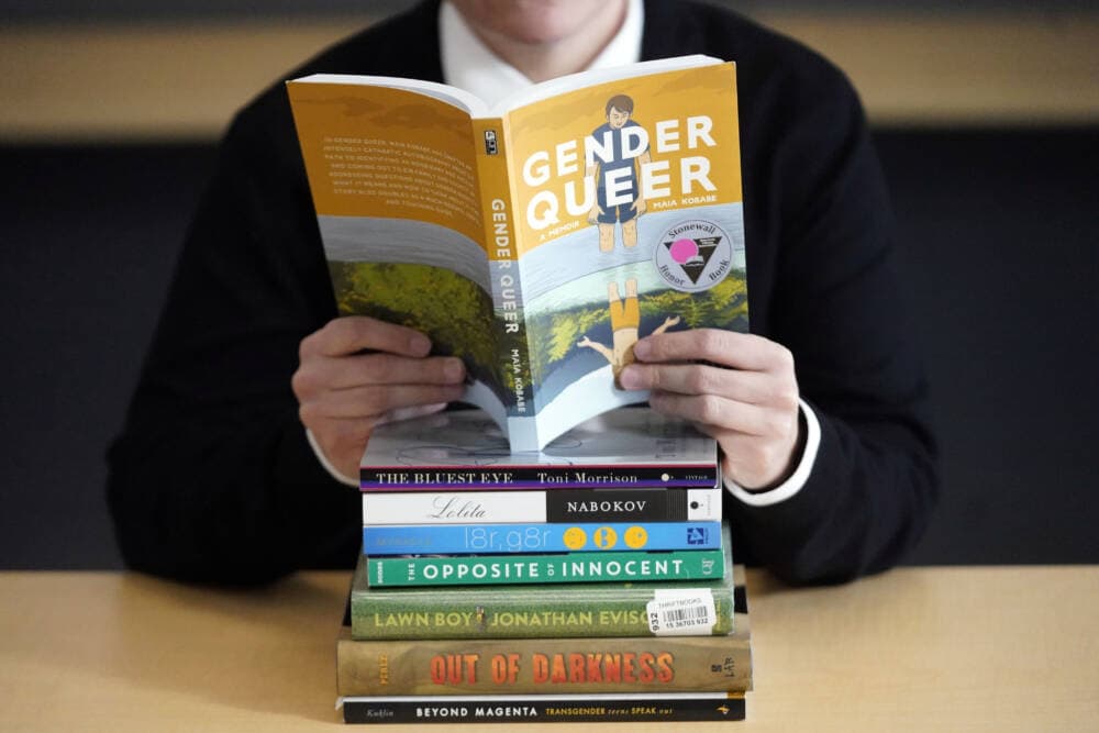 Amanda Darrow, director of youth, family and education programs at the Utah Pride Center, poses with &quot;Gender Queer: A Memoir.&quot; (Rick Bowmer/AP)