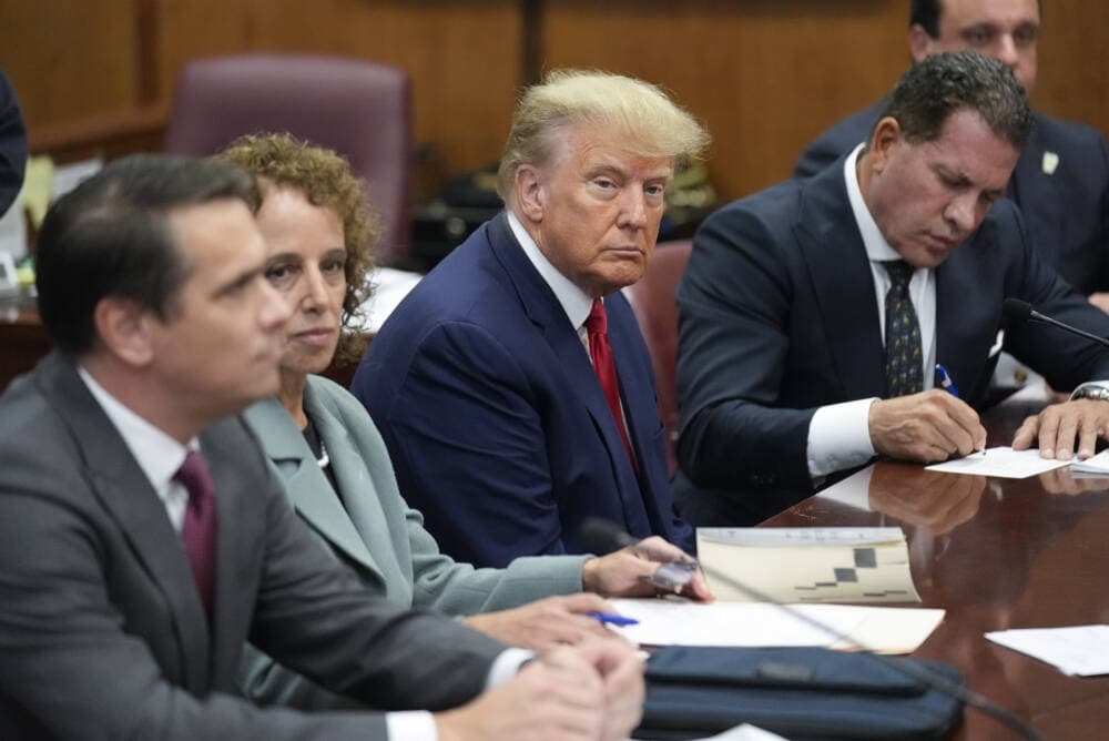 Former President Donald Trump sits with his defense team in a Manhattan court on April 4, 2023, in New York. (Seth Wenig/AP)