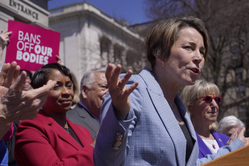Massachusetts Gov. Maura Healey talks to reporters as Attorney General Andrea Campbell, left, looks on during a news conference Monday in front of the State House in Boston. (AP Photo/Steven Senne)
