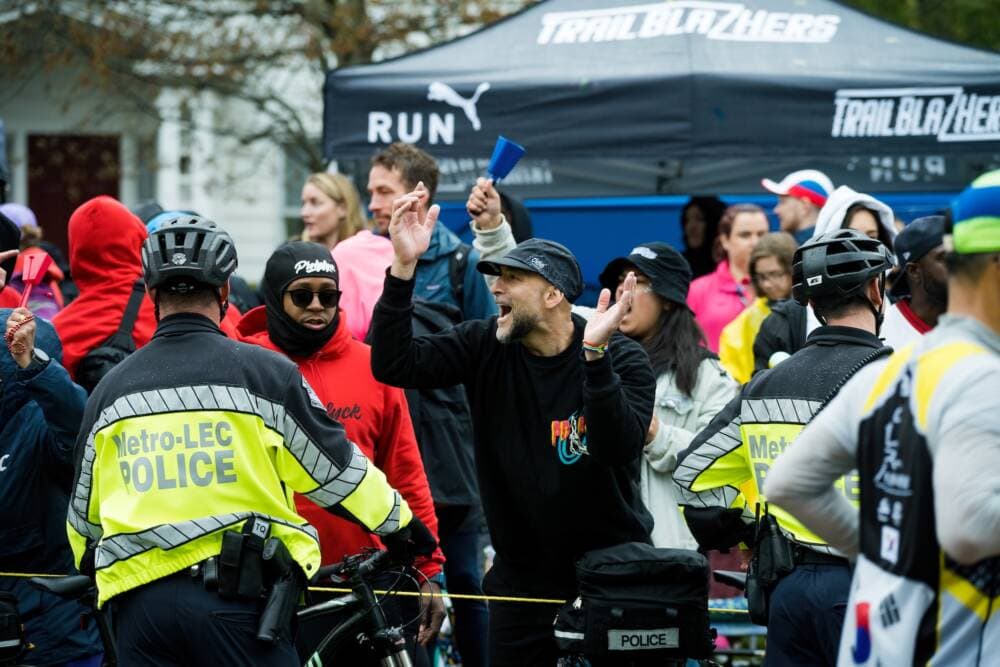 Newton police officers line up in front of the cheer zone set up by Pioneers Run Crew and TrailblazHers running clubs at the 2023 Boston Marathon. (Courtesy Dave Hashim)