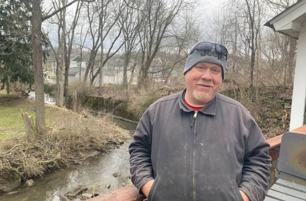 Danny Bostwick’s house in East Palestine, Ohio is only yards away from Sulfur Run. He worries that chemicals in the stream bed will soak into the soil. (Courtesy of Julie Grant / The Allegheny Front)