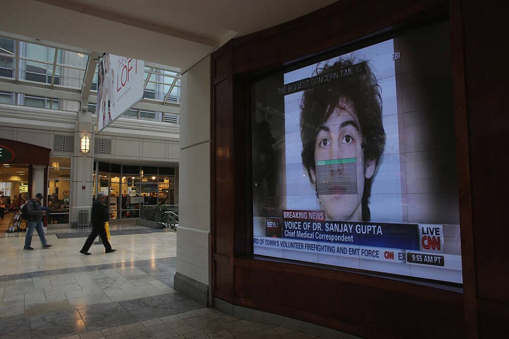 A photograph of suspect Dzhkokhar Tsarnaev is played on a television in a shopping center near the site of the Boston Marathon bombings on April 23, 2013 in Boston, Massachusetts. (Mario Tama/Getty Images)